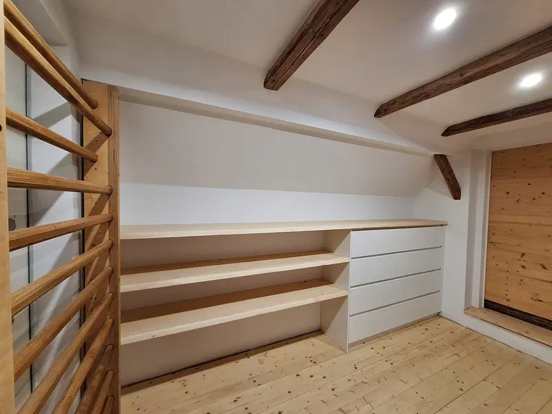 Einbauregal aus Holz unter der Dachschräge